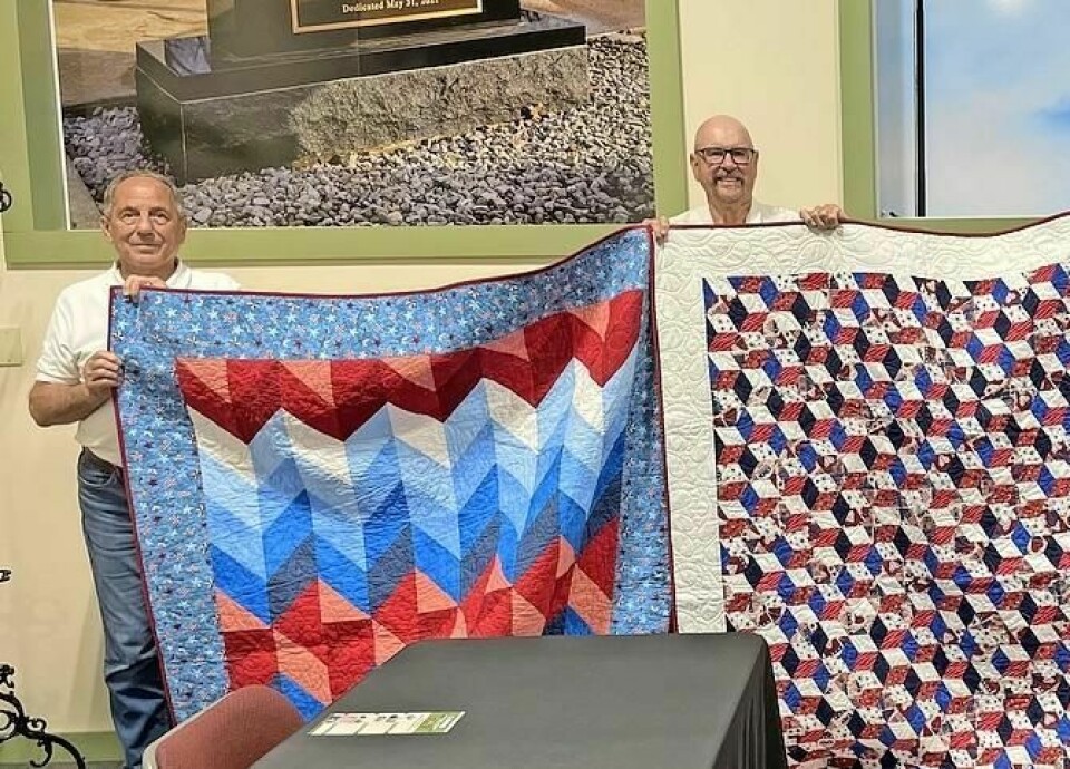 Members of the Honoring Our Patriots’ Service Committee Greg Long, left, and Tom White hold up some of the quilts that will be awarded to Wayne County veterans during the upcoming Wayne County Fair. Long and White are veterans, and White also is a member of the senior fair board. HOPS presenting quilts to veterans on Sept. 11 at fair