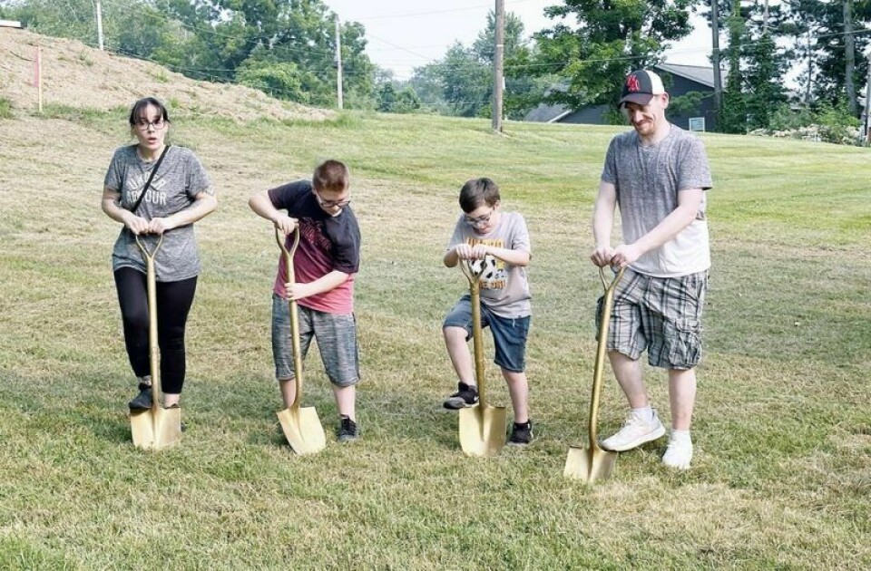 The Whitman family including Jennifer, left, Chase, Cruz and Michael dig their golden shovels into the earth, signifying the first groundbreaking for their new Habitat for Humanity Home in Millersburg. Whitman family eager to partner with Habitat for Humanity