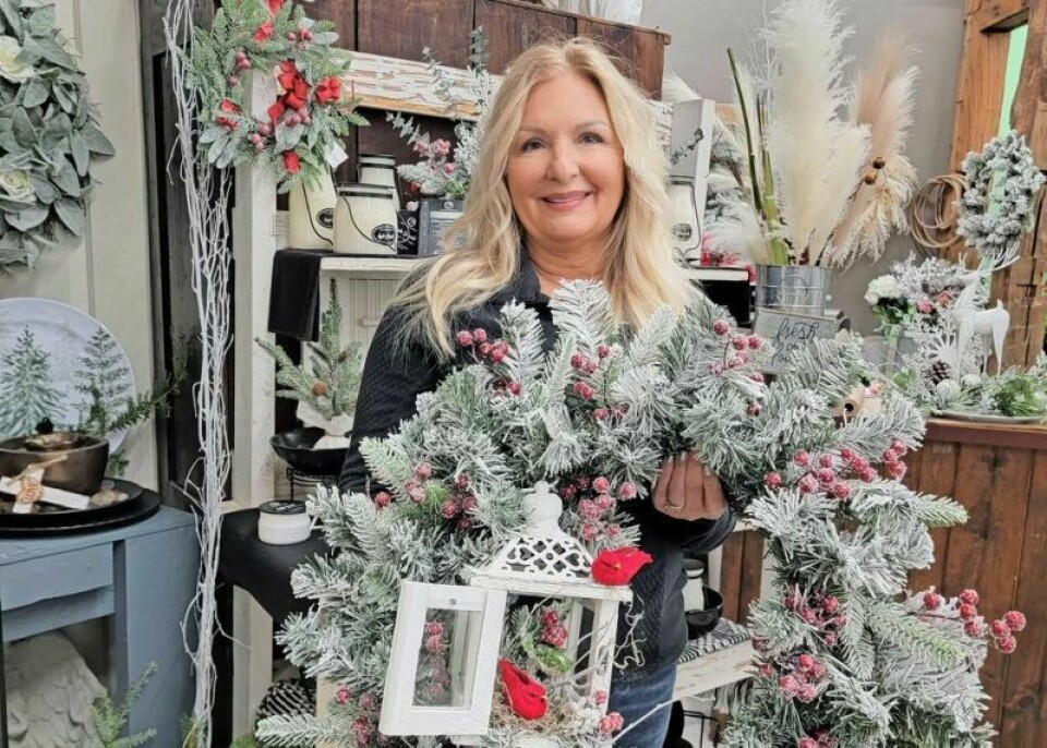 Dana Arnold holds one of her seasonal wreaths inside her flower shop The Vinery, located within Trail Side Deli in Millersburg. The shop will celebrate its 25th anniversary this year with a customer appreciation and open house Dec. 7-8 from 10 a.m. to 5 p.m. The Vinery celebrating 25th anniversary on Dec. 7-8