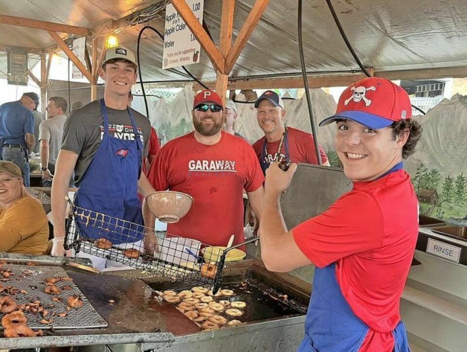 Gabe Amicone, left, Darren Yosick, Chip Amicone and Ethan Kimble are some of the many volunteers who have helped the Garaway Athletic Booster Club take over the task of making apple fritters at the annual Ohio Swiss Festival. Apple fritters have been synonymous with the festival since its earliest days. Garaway Athletic Dept. carrying on Swiss Festival fritter tradition