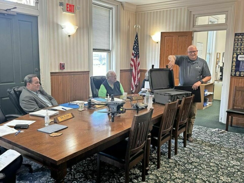 Jason Troyer, Holmes County EMA director, explains the capabilities of the department’s newly purchased drone to Holmes County commissioners Dave Hall, left, Joe Miller and others in a recent meeting. Holmes EMA flying high after purchasing new drone