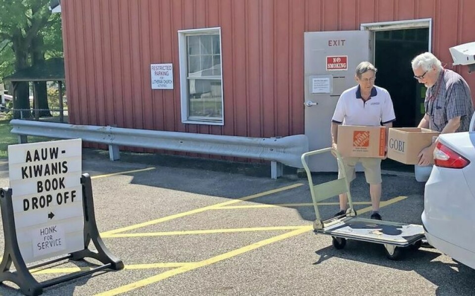 Volunteers Paul Noser and Peter Roberts unload a donation of used books for the upcoming AAUW/Kiwanis Used Book Sale. Used books needed for upcoming sale