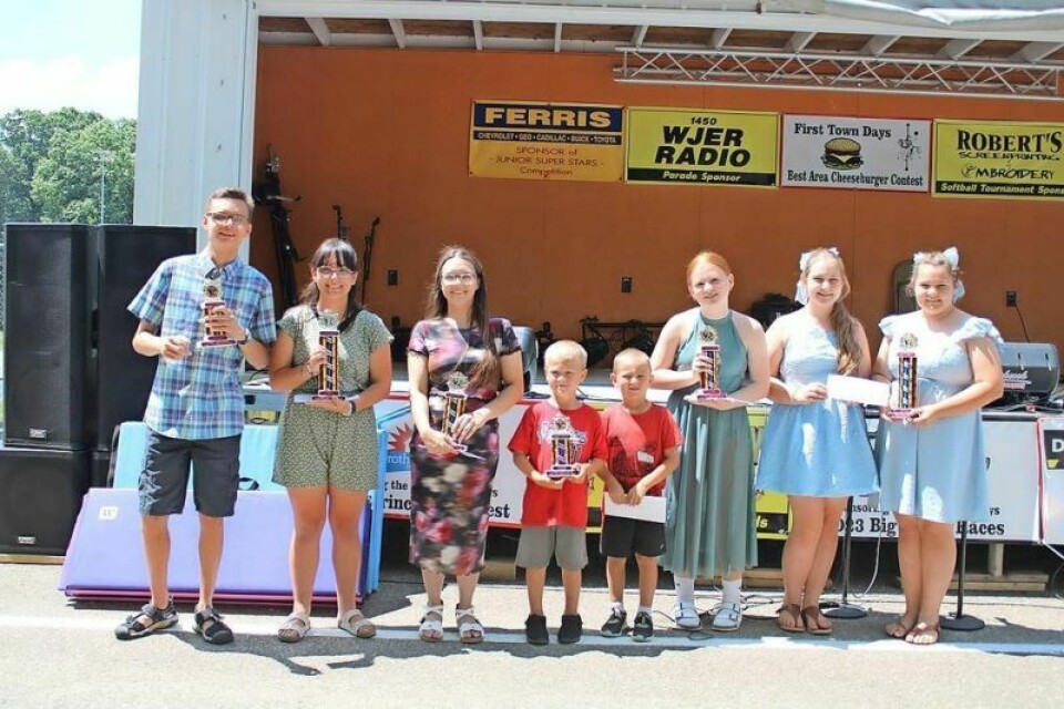 The winners of the 2024 First Town Days talent show were Aden Lambert, left, Cheyenne Millard, Renita Ecenbarger, Jonah Brinkley, Benji Bolin, Aria Sanner, and Aria and Isla Dotts. Winner learned to play the guitar in 2 weeks