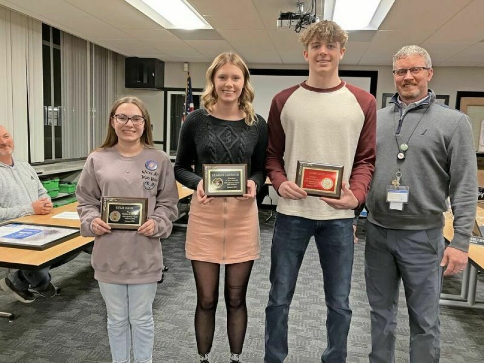 Kylie Daum, left, Kearah Ladrach, John Leffler and High School Principal Jason Phillips Members receive awards