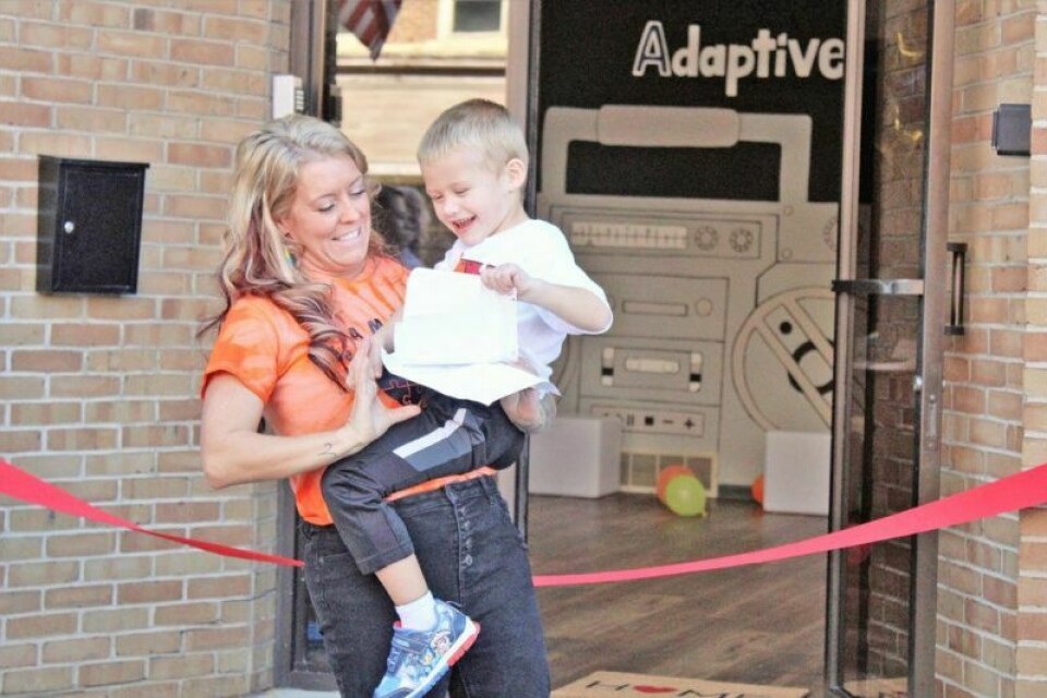Cash Stephen, 4, steals notes from his mother Lacey Herbert-Stephen before the ribbon cutting of the Adaptive Movement Center. Adaptive Movement Center hosts grand opening event