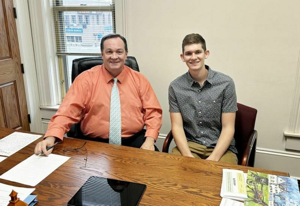 Holmes County commissioner Dave Hall, left, sits with Hiland senior Alex Yoder in Hall’s office before the two headed to WKLM radio station to help with the United Way fundraising effort to support Dolly Parton’s Imagination Station. Hall shows Yoder a day in the life of local government