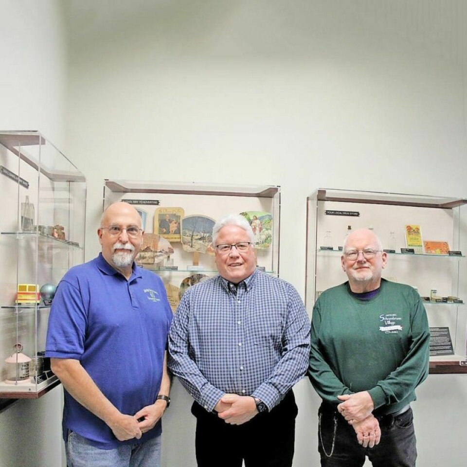 New Philadelphia Mayor Joel Day, center, with Tuscarawas County Heritage Home Association members Tom Strickling, left, and George Laurence. Part of New Philadelphia collection on display at mayor’s office