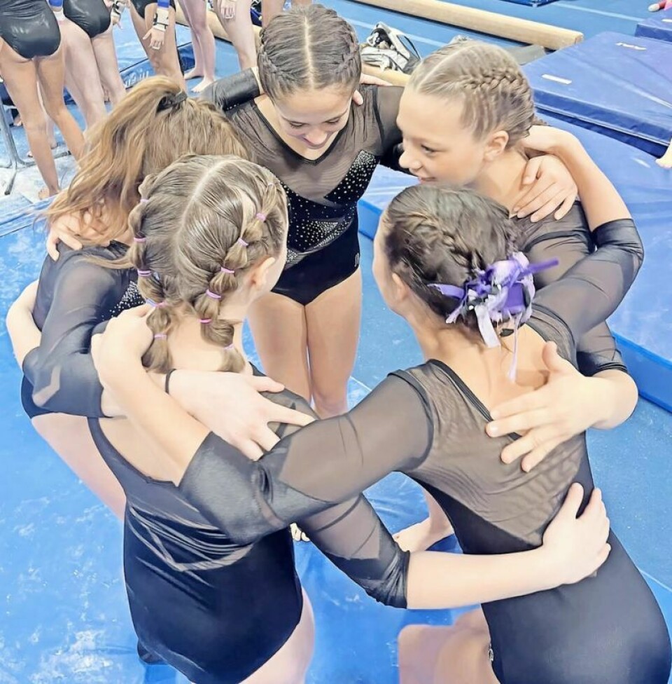 Level Xcel Gold Team unifying before competition begins: Penelope Endlich, front left, Kendall Geers, Sofia Secrest, Lily Endlich and Gracyn Beaber. YMCA hosts NEO league gymnastics meet