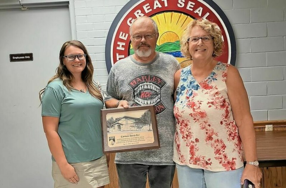 Dave Ely, center, was honored during the July 15 Sugarcreek Village Council meeting for his dedication and service of 48 years to the village. Ely retired as a police officer in April 2024. Ely honored during recent Sugarcreek council meeting