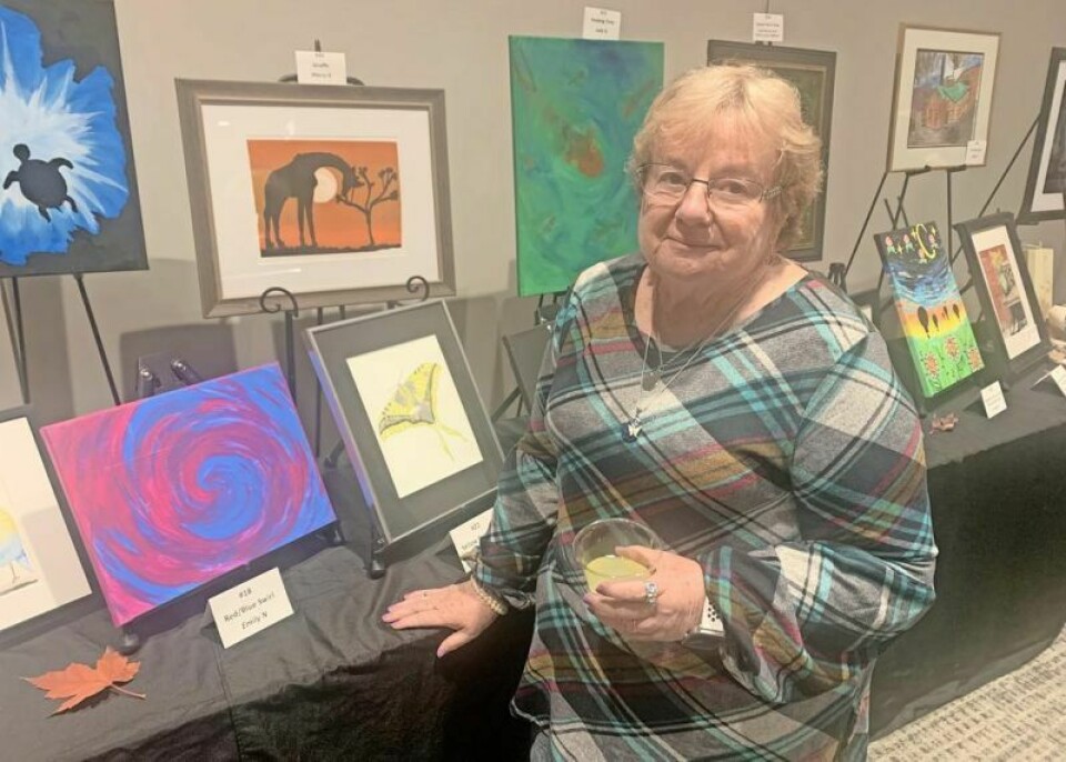 MOCA House participant Emily Nulph gets ready for the recent Expressions of Hope Art Auction at The Connection Conference & Event Center in Wooster. Nulph’s acrylic “Red/Blue Swirl” was among the works up for bid. Art auction showcases works of MOCA House