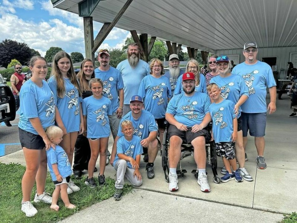 Nathan Wheeler is surrounded by family and close friends during the recent softball benefit held at Killbuck Park on Saturday, June 6. Wheeler said he felt the love from everywhere as people poured into the park to show their support and commitment to helping him raise funds. A grand day is dedicated to ‘Wheels’