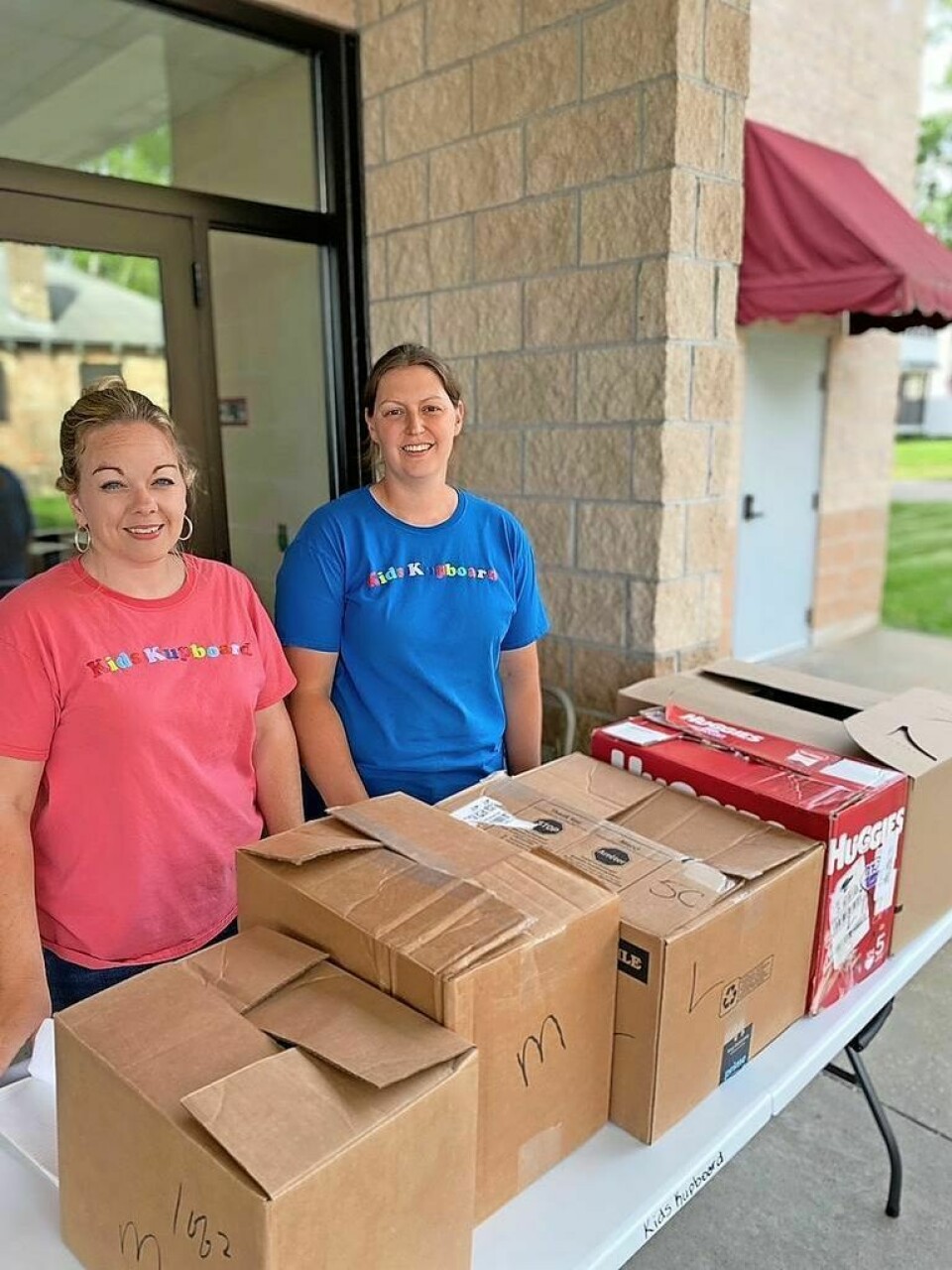 Becky Barker and Alisha Gladman prepare food boxes. Food assistance volunteers seek support