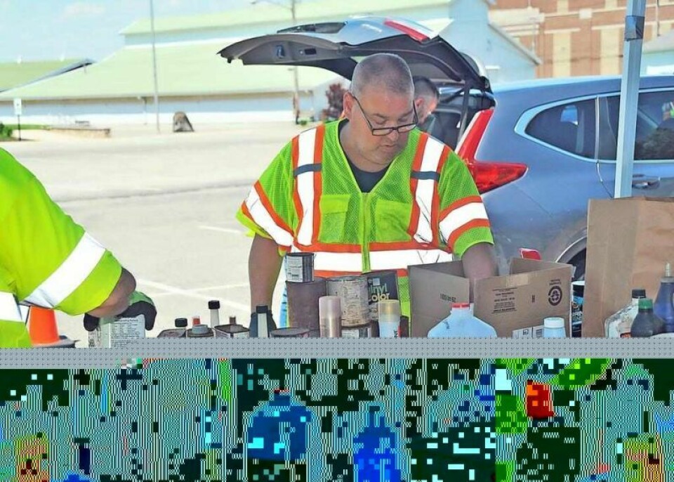 Bill Krasienko of Chemtron separates containers according to their chemical contents for proper disposal. Some materials will be safely incinerated while others will be reused, diverting them from the landfill and protecting the water tables. Wayne County hazardous waste collection event keeps growing