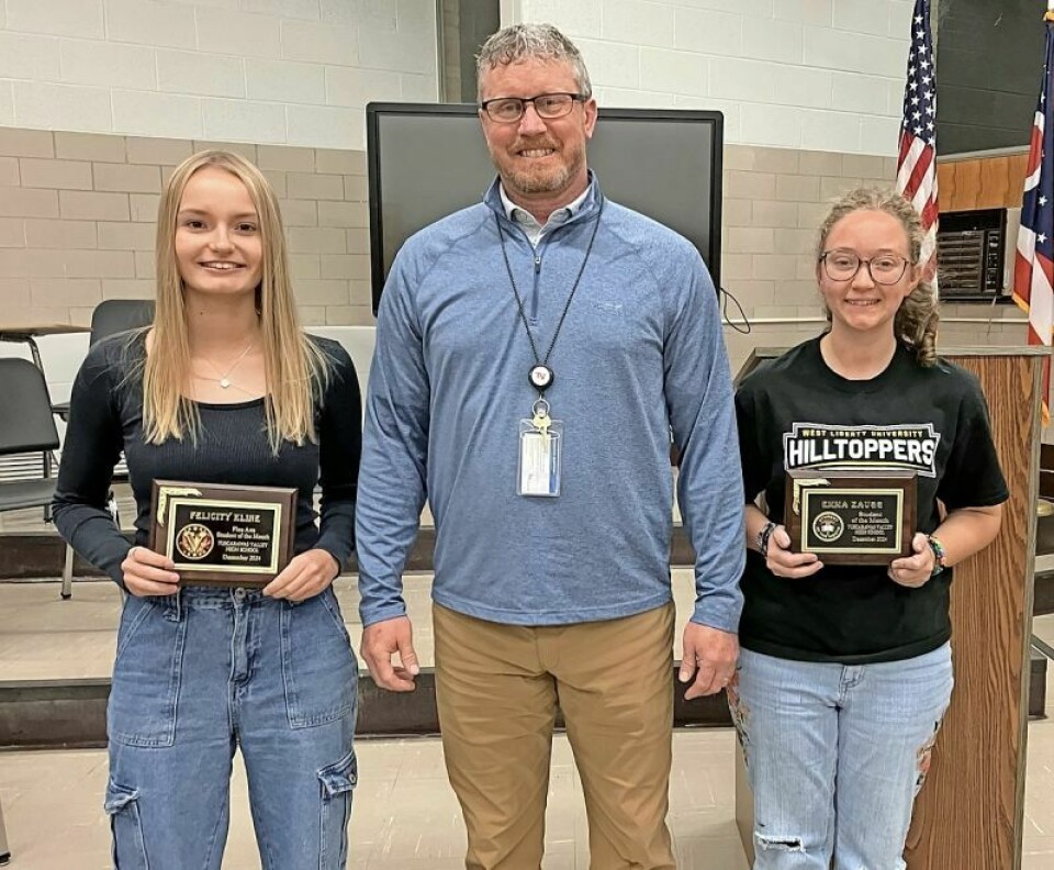 Felicity Kline, fine artist, left; High School Principal Jason Phillips; and Emma Zaugg, Student of the Month. Board accepts resignation with regret