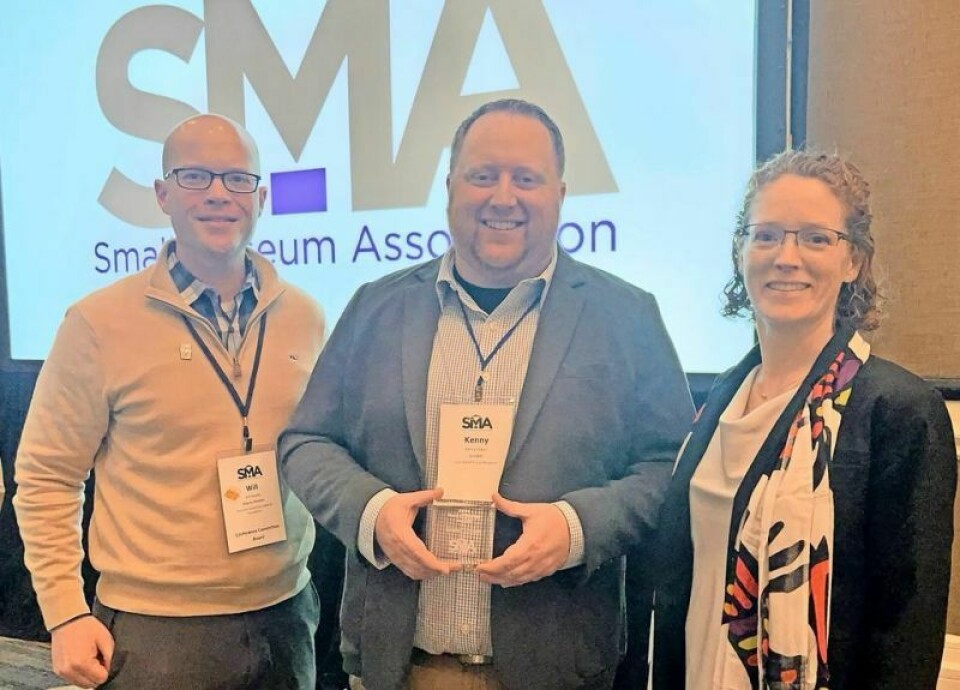 Small Museum Association President Kristen Butler, right, and Vice President William Roulett, left, present Cleo Redd Fisher Museum curator Kenny Libben with the Hunter-Burley Award, recognizing an individual’s outstanding contributions to the advancement of public access and professional growth for an individual institution. CRF Museum curator Libben wins national award