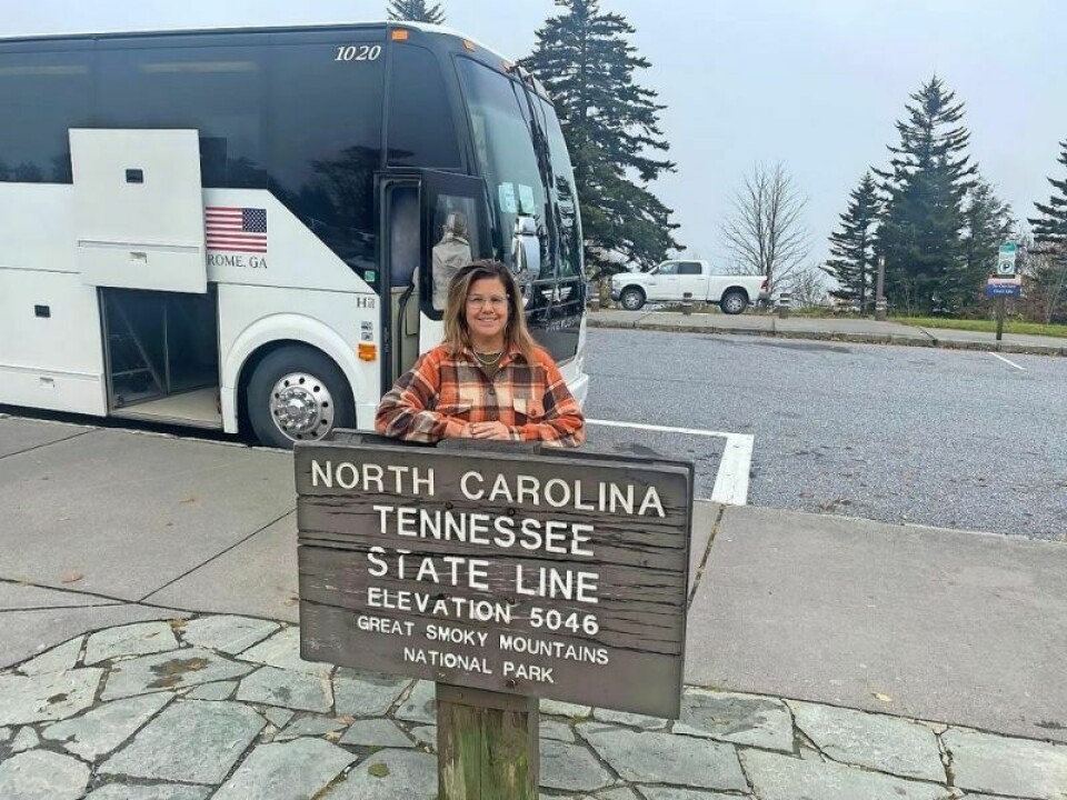 Vicki Yates of the TCSC, a trip escort, stands at the border line of North Carolina and Tennessee on a trip to the Smokey Mountains earlier in 2023. New trip added to the 2024 senior center schedule