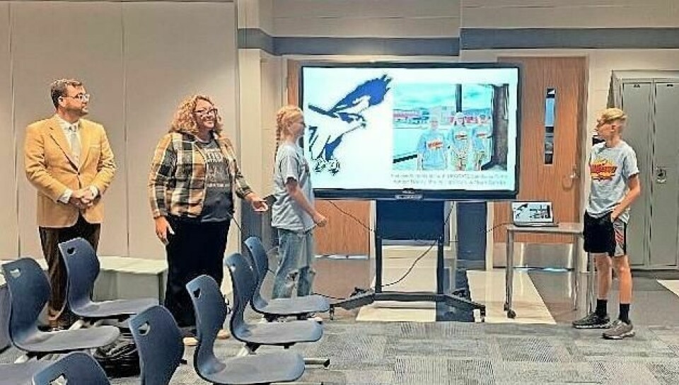 Bluecoats CEO Mike Scott, left, Fairless Band Director Elizabeth Barkan, and students Ashton Haney and Noah Barkan give a presentation to the board of education. BOE forms partnership with Bluecoats marching ensemble