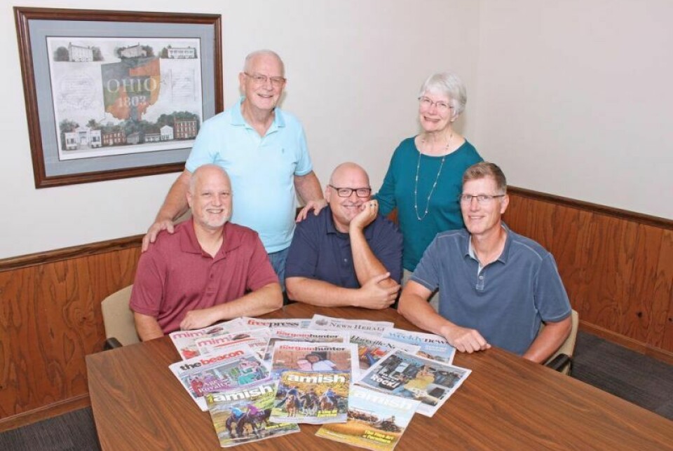 Abe and Fran Mast, back, began publishing The Holmes Bargain Hunter in September 1973. Fifty years later, the company, now owned by their sons Dave, left, Michael and John, publishes a dozen weeklies.
