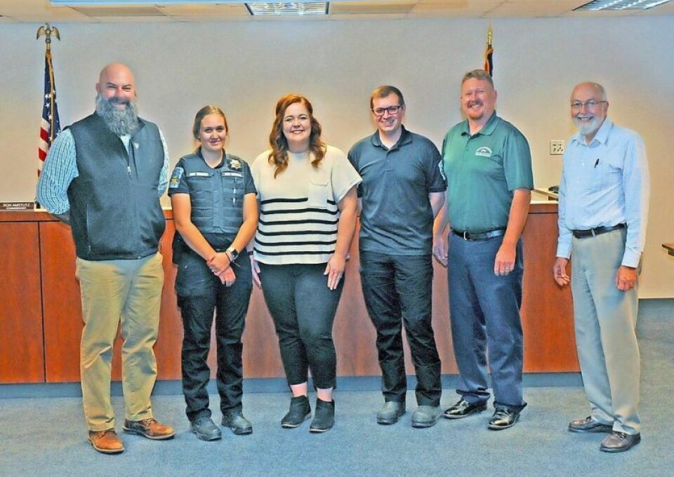 Jenna Cutshaver, second from left, poses with County Commissioner Dave McMillen, left, Dog Warden and Shelter Director Katelyn Lehman, Deputy Dog Warden Dakota Snure, Commissioner Jonathan Hofstetter and Commissioner Ron Amstutz after being sworn in as deputy dog warden for the Wayne County Dog Shelter and Adoption Center. Cutshaver sworn in as deputy dog warden