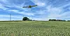 jet flying over farmland
