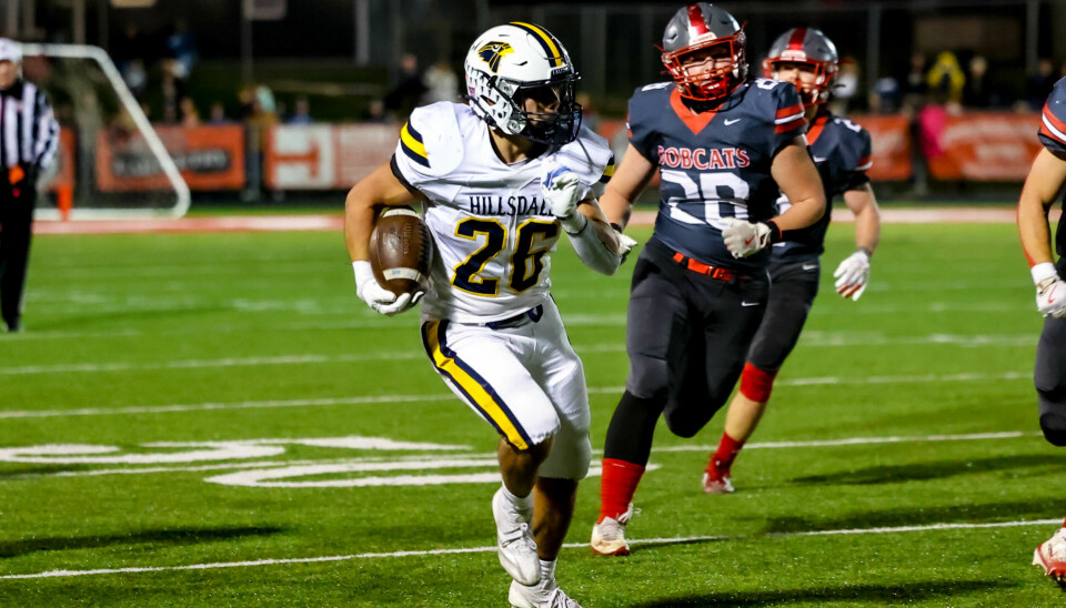 Owen Sloan races for some yards with Norwayne's Wyatt Ruch closing in here in the second half.
