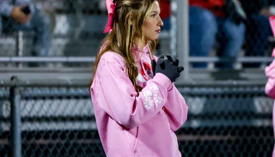 Norwayne cheerleader Reece Urban watches the play on the field late in the second half as the Bobcats sealed up the win.