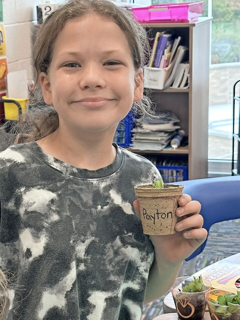 Payton Harris holds her plant last school year. Steele said the joy of the students is what prompted her to pursue the hydroponics.